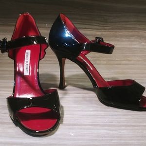 Manolo Blahnik black patent leather strap heel with red leather insole.